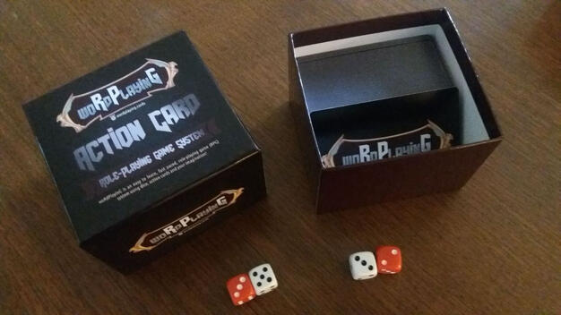 Open woRdPlayinG box with dice and card back showing